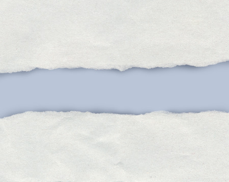 Torn paper edge showing a light blue background with copy spaceの写真素材