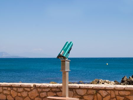 Telescope near a wall looking out to seaの写真素材