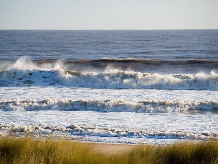 View of the sea with Waves breaking onto a beachの写真素材