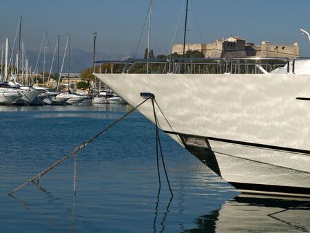 Front of a boat with boats and fort in the backgroundの写真素材