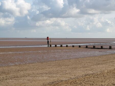 Warning posts on a sandy beachの写真素材