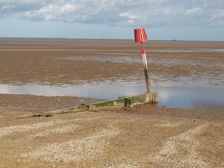 Warning posts on a sandy beachの写真素材