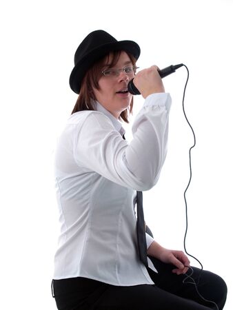 Young woman singing into a microphoneの写真素材