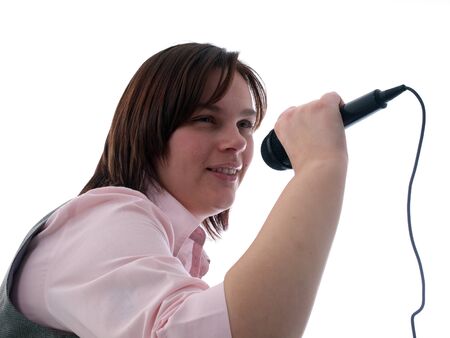 Young woman singing into a microphoneの写真素材