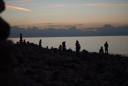Rock pillars on a beach at Klint StensÃ¸jler in Denmark at nightの写真素材