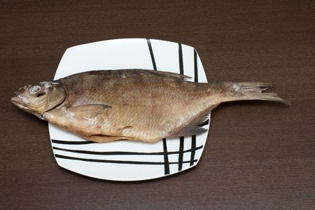 Smoke-dried fish on the modern plate 
