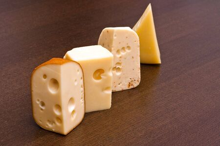 Row of four cheeses on the tableの写真素材