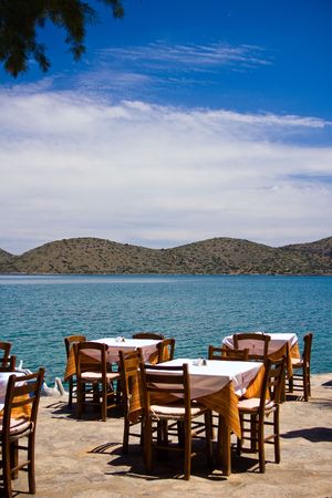 Tables and chairs of restaurant on a coastの写真素材