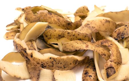 Heap of potato peelings isolated on white background