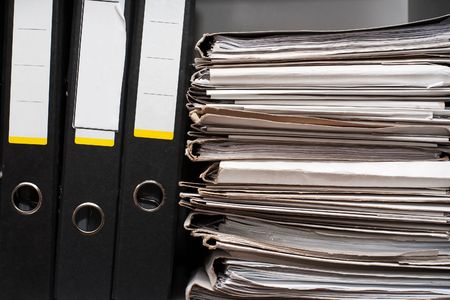 Three folders and pack of documentsの写真素材