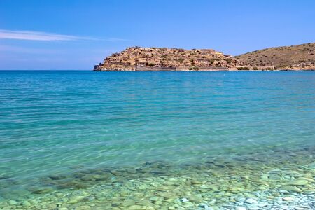 The view of the Spinalonga Island from the pebble beach, Crete, Greeceの写真素材