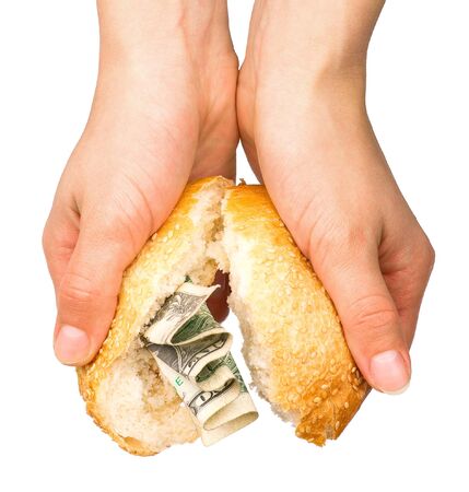Hands holding the bun stuffed with moneyの写真素材