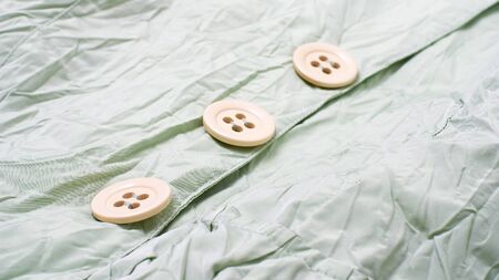 Green jacket with three round buttons, background の写真素材