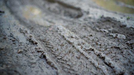 Dirty impassable road in a muddy seasonの写真素材