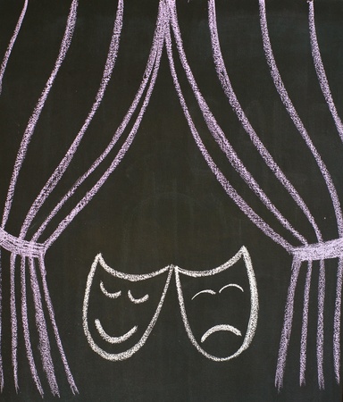 Comedy and tragedy masks at the theatre, drawn on a blackboardの写真素材