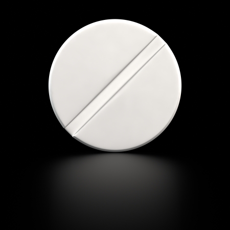 Big white tablet of round shape on the black backgroundの写真素材