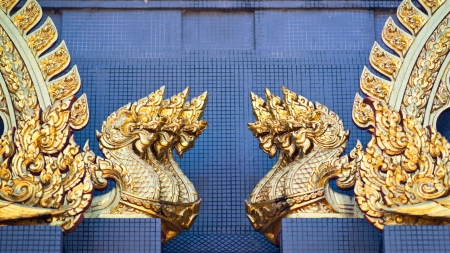 Sculptures of golden dragons on the wallの写真素材