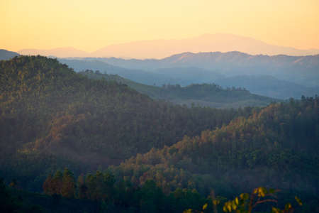Mist in the mountains at sunset in northern Thailandの写真素材