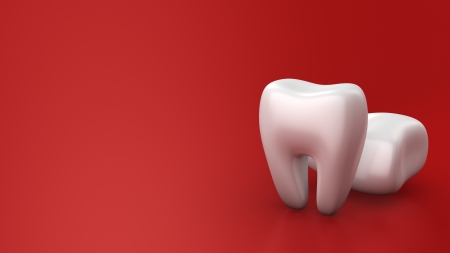 Two white teeth on red background with copyspaceの写真素材