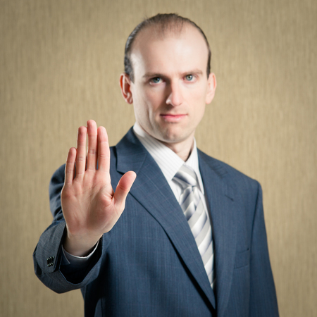 Businessman making stop gesture. Focus on the palmの写真素材
