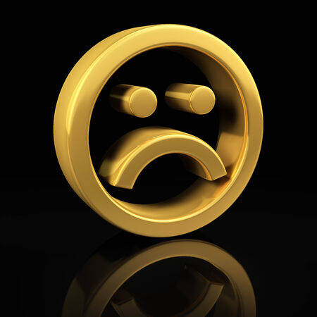 Sad smile gold symbol on a black background with reflectionの写真素材