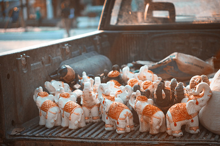 Many clay elephants in the trunk of pickupの写真素材