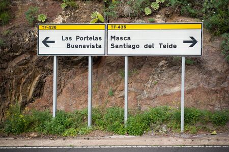 Road signs direction to famous landmarks of Tenerife. Right to the Masca gorge, left to the Buenavistaの写真素材