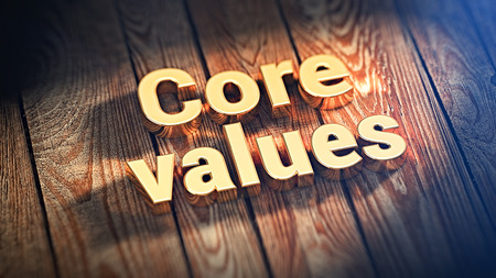 The words "Core values" is lined with gold letters on wooden planks. 3D illustration imageの写真素材