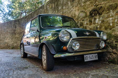 Florence, Italy - April 29, 2016. Car Mini Cooper MKVI parked next to old stone wallのeditorial素材
