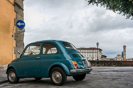 Florence, Italy - April 18, 2016. Vintage car Fiat 500 parked near embankment of river Arno in Florence.のeditorial素材