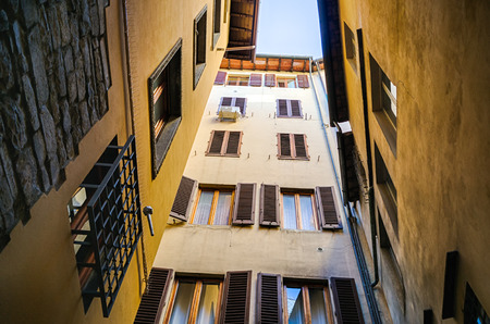Look at the sky from a courtyard of a multistory building in Florence, Italyの写真素材