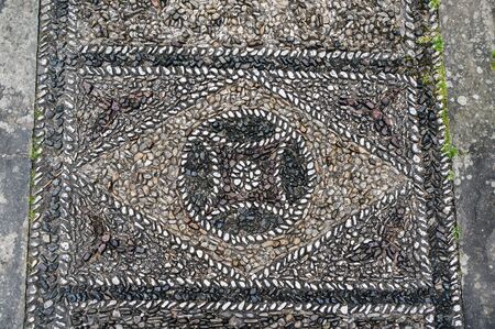 Abstract geometric mosaic from pebble stones on the floor of Palazzo Medici Riccardi in Florence, Italyの写真素材