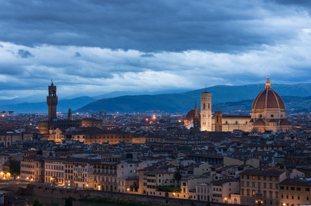 Cityscape of Florence with famous landmarks - the Cathedral Santa Maria del Fiore and Palazzo Vecchio on the opposite riverside. View from piazzale Michelangelo at sunrise.の写真素材