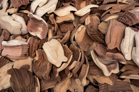 Many details of human hands carved from the wood. Traditional product of handicraft on Bali, Indonesia.の写真素材