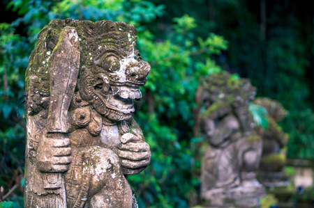 Sculpture of a guardian carved from the stone in traditional balinese style