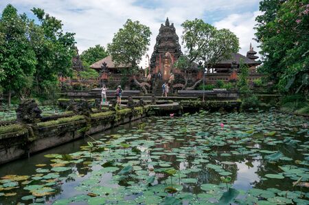 BALI, INDONESIA - OCTOBER 26, 2016: Group of tourists  are warking along the lotus pond in Saraswati temple in Ubud town, Bali, Indonesiaのeditorial素材