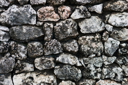 The wall made from rough grey cobblestonesの写真素材