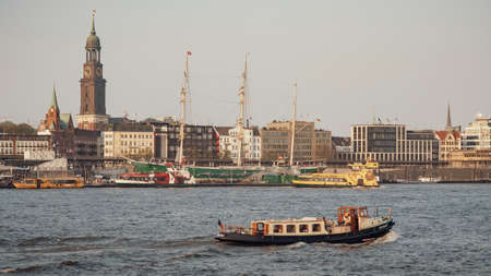 Hamburg, Germany, 20 April 2018: Sightseeng tour by boat over the Elbe river along the hanseatic city of Hamburg. There is famous landmark St. Michael church on the riverside.のeditorial素材