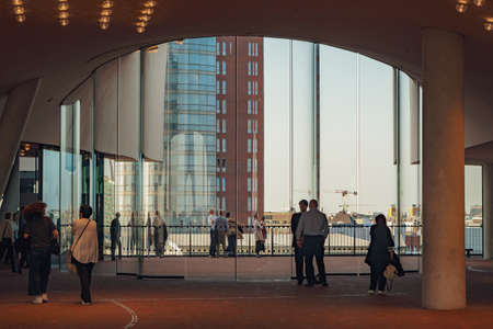 Hamburg, Germany - april 18, 2018: Visitors of Elbe Philharmonic Hall (Elbphilharmonie) are waiting for the concert in modern hall with glass window.のeditorial素材
