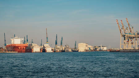 Cargo crane over evening sky background. Hamburg port on Elbe river in Germany.