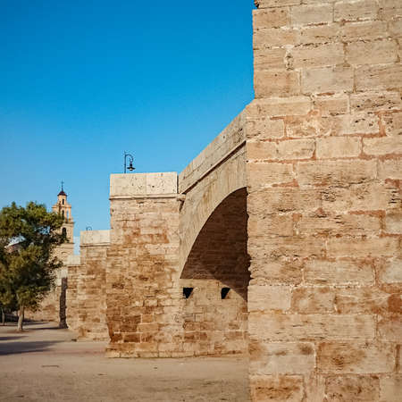 View on the church of Santa Monica from under Serranos Serranos bridge in the Turia garden.の写真素材