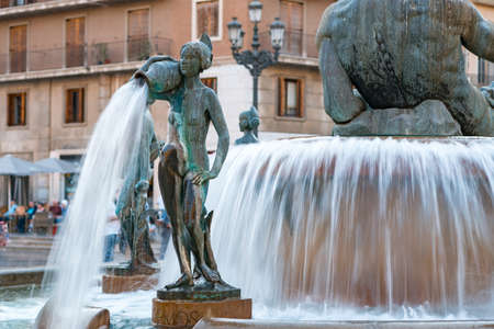 Valencia, Spain - 28.10.2019: The statue of naked woman with a pitcher - detail of the Neptune fountain. Fountain is located on the square Plaza de la Virgen in the historic center of Valencia.のeditorial素材