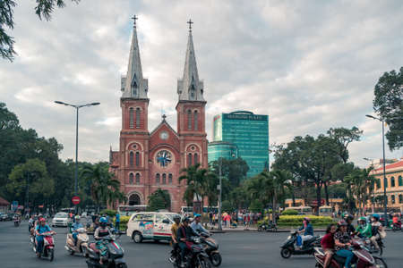 Ho Chi Minh city, Vietnam - February 15, 2017: Motorbike traffic on the road next to The Notre-Dame Cathedral Basilica of Saigonのeditorial素材