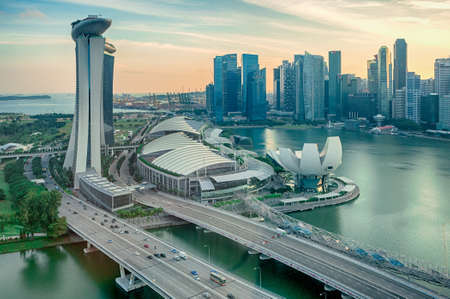 SINGAPORE - SEPTEMBER 15, 2016: Top view at Marina Bay of Singapore at sunset with main landmarks of the city - Artscience museum, financial skyscrapers, Marina Bay Sands resort and The Helix bridgeのeditorial素材