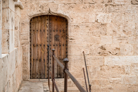 Wooden door in Torres de Quart (ancient western city gate of old town Valencia).の写真素材