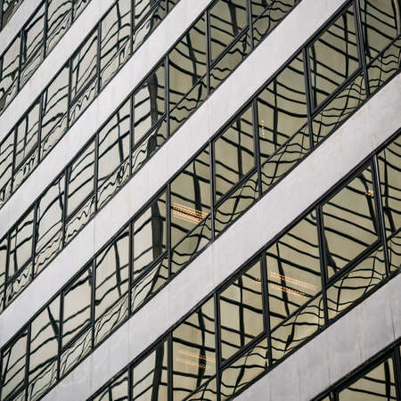 Abstract reflections in the windows of a modern building from glass and concreteの写真素材