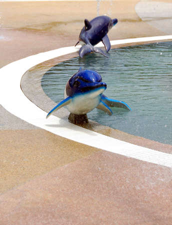 dolphine fountain in parkの写真素材