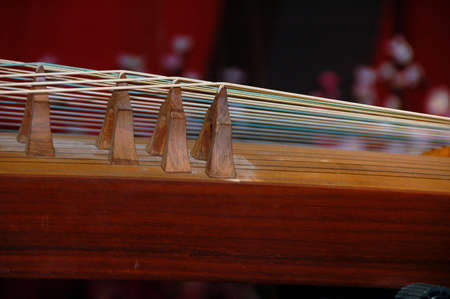closed up view of gu-jeng, an string musical instrument showing double string and fletの写真素材