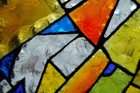 stainglass of an old church showing pattern and colorsの写真素材