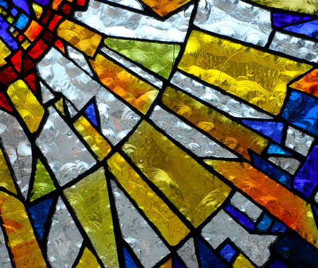 stainglass of an old church showing pattern and colorsの写真素材